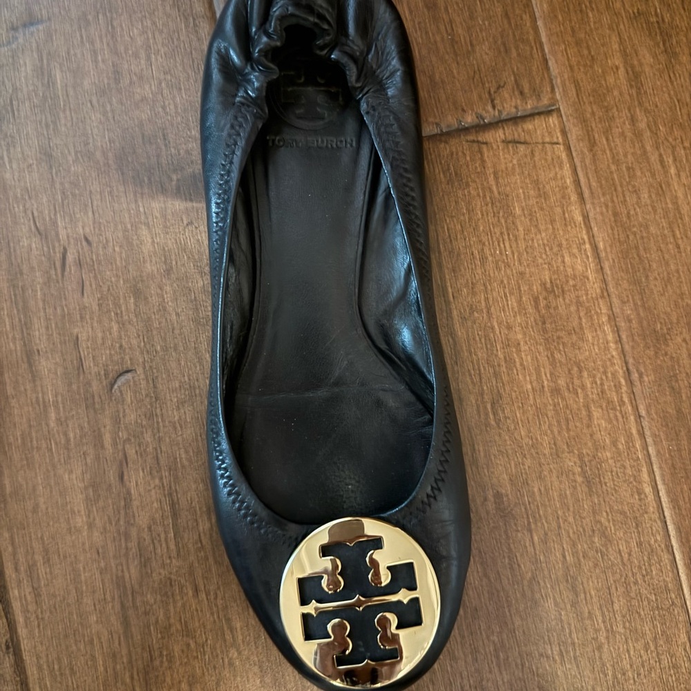 Tory Burch Black and Gold Flats with Logo Medallion